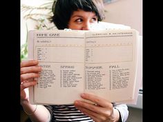 a woman reading a recipe book in front of her face