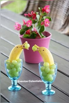 two glasses with grapes and bananas in them