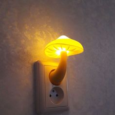 a light that is on the wall with a banana lamp attached to it's side