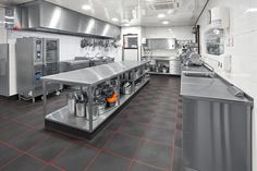 a large commercial kitchen with stainless steel appliances