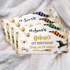 three harry potter birthday cards on top of a white blanket with gold trimmings