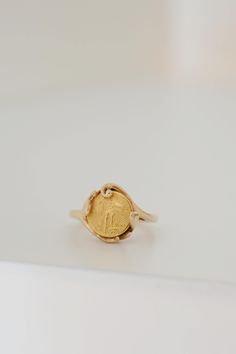 A beautiful coin ring with lots of vintage charm. The 18K coin sits in a 14K handmade mount accented with organic swirls and and curves, and was likely custom made for the original wearer. The band has wonderful buttery soft gold tones, while the coin has that extra pop of brightness thanks to the higher purity. "The Saint-Gaudens double eagle is a twenty-dollar gold coin, or double eagle, produced by the United States Mint from 1907 to 1933. The coin is named after its designer, the sculptor Au Coin Ring, Gold Coins, Vintage Charms, Rings Statement, Solid Gold, Statement Rings, Gold Tones, Jewelry Rings, Band