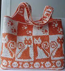 an orange and white purse sitting on top of a window sill next to a door