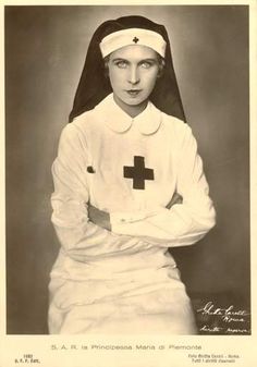 an old black and white photo of a woman in a nurse's outfit with her arms crossed