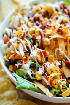 a white bowl filled with salad and tortilla chips on top of a table