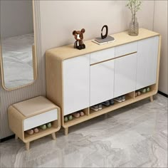 a white cabinet with two stools and a teddy bear sitting on top of it