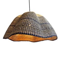 a woven lamp shade hanging from a ceiling