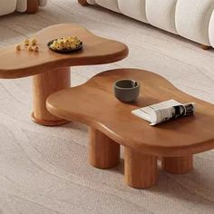 two wooden tables sitting on top of a carpeted floor