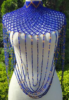 Beautifully beaded high collar body necklace. Primary color is royal blue with gold beads placed throughout a diamond shaped web design with loop accents. The fit of this necklace is a high choker cascading down the chest with delicate loop details draping the arms and torso. Body necklace measurements are as followed: The front is 14.5 inches long (measured from top of the chocker neckline down the front of the torso.  The side is 13.5 inches long (measured from shoulder and down the arm) and the diameter of the portion just around the neck is 5.5 inches (measured when closed using the middle toggle / loop). The back closure is made from 2 beaded toggles that can fit into 3 different loops to adjust diameter around the neck. Blue Beaded Necklaces For Evening, Elegant Blue Choker For Festivals, Blue Beaded Bib Necklace For Party, Blue Beaded Choker For Party, Party Blue Necklaces With Gold Beads, Beads Clothes, Necklace Measurements, Avatar James Cameron, Body Necklace