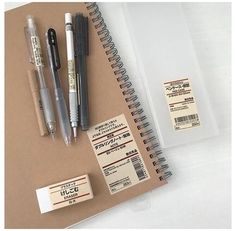 a notebook with some pens and other items on it