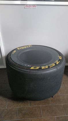 a black tire sitting on top of a tiled floor