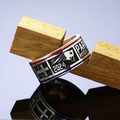 a close up of a ring on top of a wooden block with the word faith printed on it