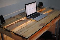 an open laptop computer sitting on top of a wooden desk