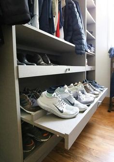 there are many pairs of shoes on the shelf next to each other in this closet