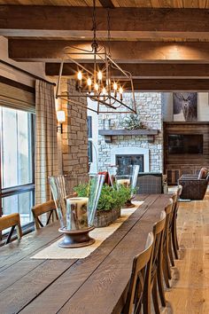 the dining room table is surrounded by chairs and tables with plants on them in vases