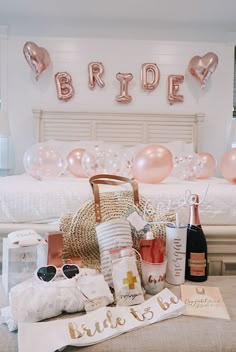 a bed room with a neatly made bed and pink balloons