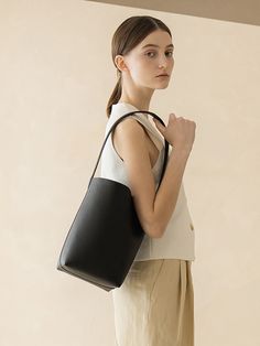 Editor's Notes object museum is a brand that develops anti-abstract and physical designs.- Textured cow leather used bucket bag- Multiple-way wearable bag- Spacious and practical design- Engraved brand logo on the front Measurements(in.)- Size: 6.69 in. / 13.19 in. * 10.63 in. * 6.30 in.- Strap: 9.45 in. Composition & Care- Cow Skin- Leather may have fine scratches and wrinkles- Bright leather can get stained by denim or dark outfits- Avoid direct heat and moisture- Wipe off m Bucket Bags Outfit, Bucket Tote Bag, Tote Outfit, Bucket Tote, Dark Outfits, Cow Skin, Bags Logo, Practical Design, Canvas Bag