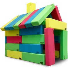 a house made out of colored blocks on top of each other with the roof missing