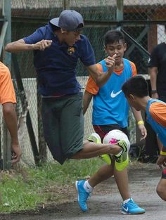 a group of young men kicking around a soccer ball