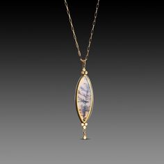 A very special dendritic agate evokes a mysterious and lovely scene in nature. The stone is wrapped in 22k gold, and accented with two 22k gold trios, and a tiny gold drop. This magical pendant is backed in sterling silver, and suspended from a 14k gold paperclip chain. Pendant measures approximately 1/2 inch x 1 3/4 inches. Matte finish. This piece is in stock and ready to ship. Unique Oval Agate Necklace, Gold Agate Necklace With Oval Pendant, Gold Moss Agate Pendant Jewelry, Gold Agate Oval Pendant Necklace, Gold Moss Agate Spiritual Necklace, Magical Pendant, Artisan Agate Pendant Necklace, Elegant Agate Pendant Gemstone, Dendritic Agate Jewelry