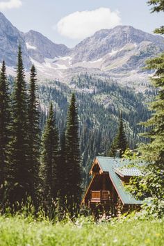 a cabin nestled in the mountains surrounded by trees