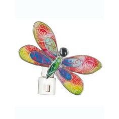 a multicolored dragonfly is attached to a light switch cover with an outlet