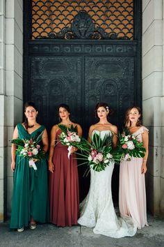 the bridesmaids are holding their bouquets in front of an ornate building door