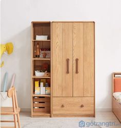 a bedroom with a bed, dresser and cupboards in it's corner area