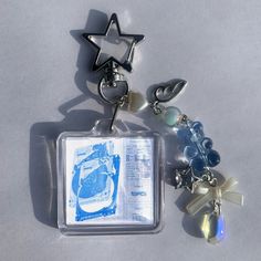 a star shaped keychain with charms attached to it