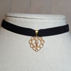 Gold Heart With Cross Gothic Style Velvet Choker Necklace. Charms Are Approximately 20x22mm. Comes On A 12 Inch Velvet Choker With A Lobster Clasp And 2 Inch Extension Chain. Gothic Gold Heart-shaped Jewelry, Gothic Gold Heart Jewelry, Elegant Black Heart Pendant Choker, Elegant Black Heart-shaped Choker, Black Heart Pendant Choker With Charm, Black Heart Charm Choker For Valentine's Day, Black Heart Pendant Choker With Heart Charm, Elegant Black Valentine's Day Choker, Black Choker For Valentine's Day Gift