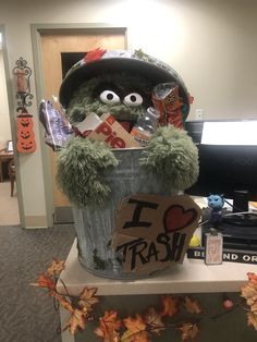 a trash can with an i love trash sign on it and some decorations around it