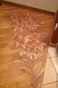 a wooden floor with flowers painted on it