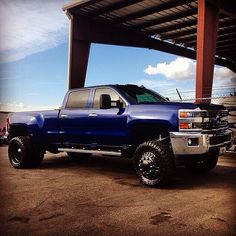 a large blue truck parked under a covered structure