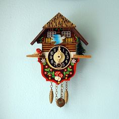 a colorful cuckoo clock hanging on the wall