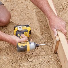 a man working on wood with a drill