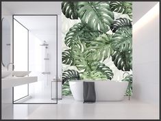 a bathroom with a bathtub, sink and large green leaves on the wall