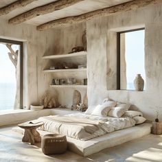 a bedroom with a large bed sitting under a window next to a book shelf filled with books