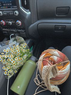 the interior of a car with flowers and yarn