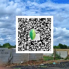 a qr - code for a green apple sitting on the side of a road