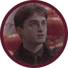 a man wearing glasses and a black shirt in a circle with an image of harry potter on it