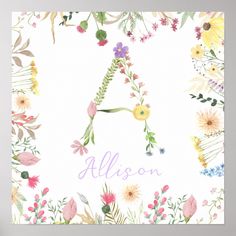 a floral letter is shown on a white background with pink, yellow and green flowers