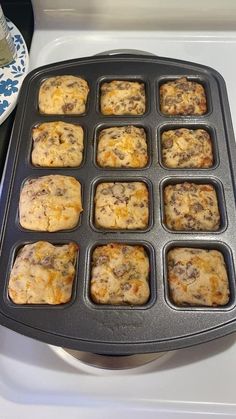 muffins in a pan sitting on top of a stove