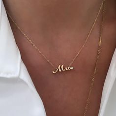 Elevate the essence of elegance with our Mrs. Gold Diamond Accent Nameplate Necklace – a stunning piece designed for those who are a Mrs. or the radiant bride-to-be. Crafted with meticulous attention to detail, this necklace features a delicately personalized script Mrs. nameplate adorned with a subtle bezel set diamond accent, adding a touch of brilliance to your everyday jewelry wardrobe. Available in 14K yellow gold or 14K white gold, this necklace exudes timeless charm, making it the perfect Gold Necklace With Diamond, Timeless Necklace, Necklace With Diamond, Jewelry Wardrobe, Timeless Symbol, Nameplate Necklace, A New Beginning, Bezel Set Diamond, Gold Necklace Women