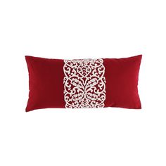 a red pillow with white embroidery on it