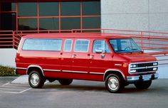 a red van parked in front of a building