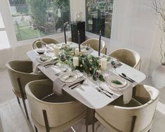 a dining room table set with white plates and place settings for six people to eat