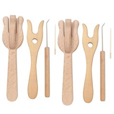 six wooden utensils are lined up next to each other