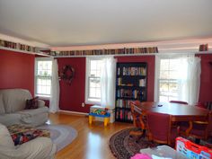 a living room filled with furniture and bookshelves