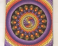 an art work with circles and dots in purple, orange, yellow and red colors