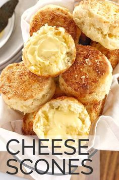 cheese scones in a basket with butter on top and the words, how to make cheesy scones